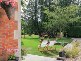 A garden with chairs and flowers at The Mount in Chippenham