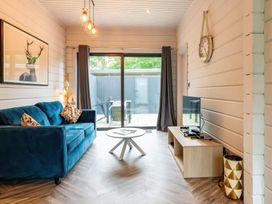 A living room with a sofa and television at Askrigg in Aysgarth
