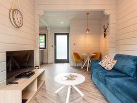 A living room with a sofa and television at Askrigg Aysgarth