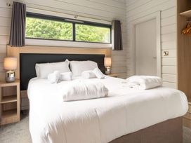 A bedroom with a bed and nightstand at Askrigg in Aysgarth
