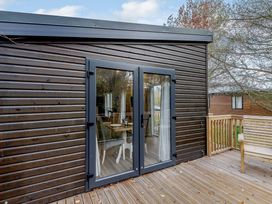 An outdoor area with sliding doors and wooden decking at Somersby (Pet) Louth