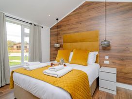 A bedroom with a bed and window at The Woodnewton in Wansford