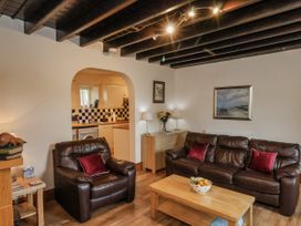 A living room with sofas and a coffee table at 2 High Stakesby Cottages in Whitby