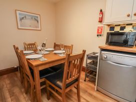 A dining room with a table and chairs at 2 High Stakesby Cottages in Whitby