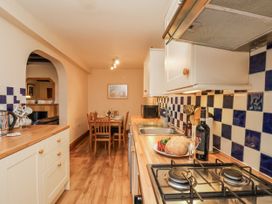 A kitchen with a dining table and chairs at 2 High Stakesby Cottages in Whitby