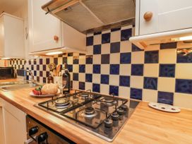 A kitchen with a gas stove and sink at 2 High Stakesby Cottages Whitby