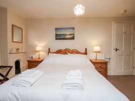 A bedroom with a bed and bedside lamps at 2 High Stakesby Cottages in Whitby