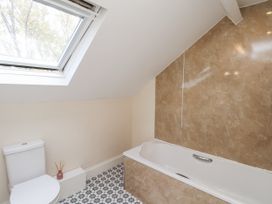 A bathroom with a bathtub and toilet at 2 High Stakesby Cottages in Whitby