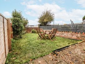 A garden with a table and chairs at 2 High Stakesby Cottages in Whitby