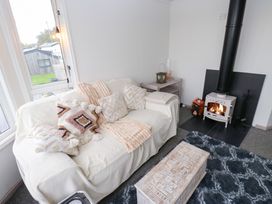 A living room with a couch and fireplace at John's Folly