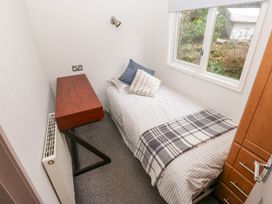A bedroom with a bed and desk at John's Folly