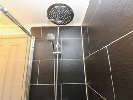 A shower with slate tiles and a shower head at John's Folly
