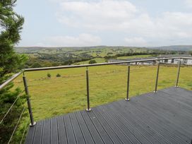 A deck with a view of hills and fields at John's Folly