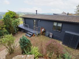 An outdoor area with a house and garden at John's Folly