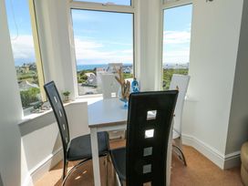 A dining area with a table and chairs at 19 Cliff Apartments in Trearddur Bay