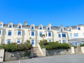 A building with windows and plants at 19 Cliff Apartments in Trearddur Bay