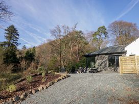 An outdoor area with a gravel driveway and chairs at The Old Bunkhouse in Grasmere