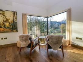 A living room with chairs and a table at The Old Bunkhouse in Grasmere