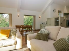 A living room with a sofa and dining area at The Old Bunkhouse in Grasmere