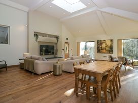 A living room with a sofa, dining table, and television at The Old Bunkhouse in Grasmere