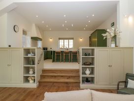 A kitchen with bar stools and a refrigerator at The Old Bunkhouse in Grasmere