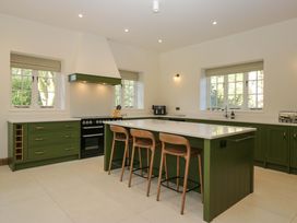 A kitchen with a countertop and stools at The Old Bunkhouse in Grasmere