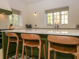 A kitchen with bar stools and a countertop at The Old Bunkhouse in Grasmere