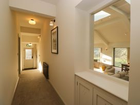 A hallway with a door and a window view at The Old Bunkhouse in Grasmere