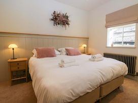 A bedroom with a large bed and bedside tables at The Old Bunkhouse in Grasmere