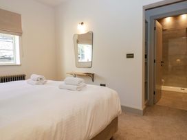 A bedroom with a bed and mirror at The Old Bunkhouse in Grasmere