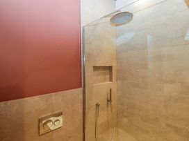 A shower area with a wall and niche at The Old Bunkhouse in Grasmere