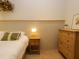 A bedroom with a bed and bedside table at The Old Bunkhouse in Grasmere