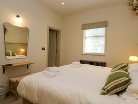 A bedroom with a bed and a mirror at The Old Bunkhouse in Grasmere