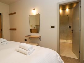 A bedroom with a bed and towels at The Old Bunkhouse in Grasmere