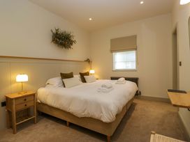 A bedroom with a bed and bedside table at The Old Bunkhouse in Grasmere