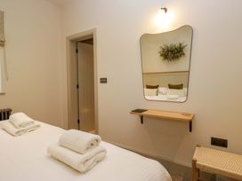A bedroom with a bed and towels on the sheets at The Old Bunkhouse in Grasmere