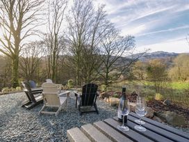 Outdoor seating area with chairs and drinks at The Old Bunkhouse Grasmere