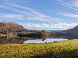 A lake surrounded by mountains and trees at The Old Bunkhouse in Grasmere