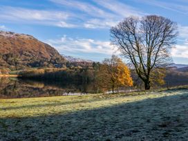 A lake surrounded by trees and mountains at The Old Bunkhouse in Grasmere