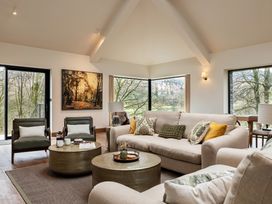 A living room with a sofa, armchairs, and a coffee table at The Old Bunkhouse in Grasmere
