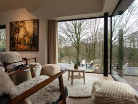 A living room with a view and an armchair at The Old Bunkhouse in Grasmere