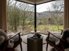 A snug with two armchairs and a coffee table at The Old Bunkhouse in Grasmere