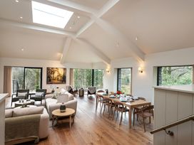 A living room with a dining area and windows at The Old Bunkhouse in Grasmere