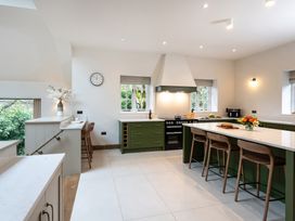 A kitchen with countertop and bar stools at The Old Bunkhouse in Grasmere