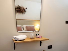 A bedroom with a mirror and shelf at The Old Bunkhouse in Grasmere