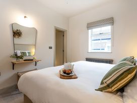 A bedroom with a bed and a shelf with a teapot at The Old Bunkhouse in Grasmere
