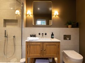 A bathroom with a shower, sink, and toilet at The Old Bunkhouse in Grasmere