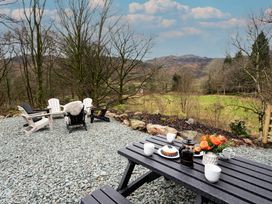 An outdoor seating area with a table and chairs at The Old Bunkhouse in Grasmere