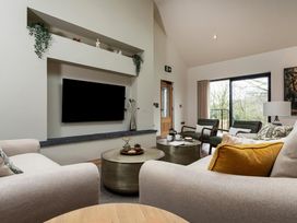 A living room with a television and coffee table at The Old Bunkhouse in Grasmere