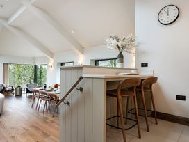 A dining room with a bar counter and stools at The Old Bunkhouse in Grasmere